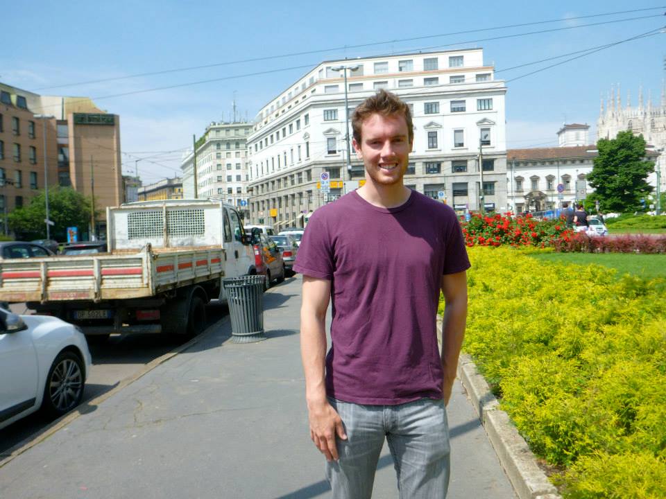 Derek standing outside in a purple shirt